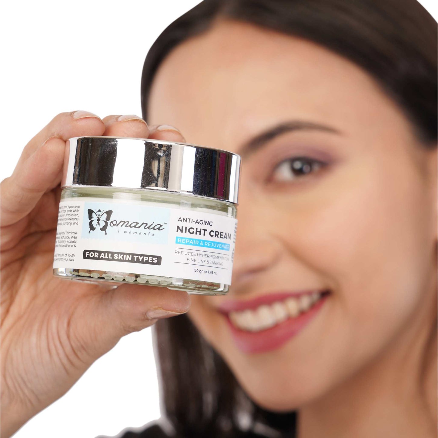 Anti-aging night cream jar with retinol and aloe, 50 gm, held by a smiling woman, suitable for all skin types.