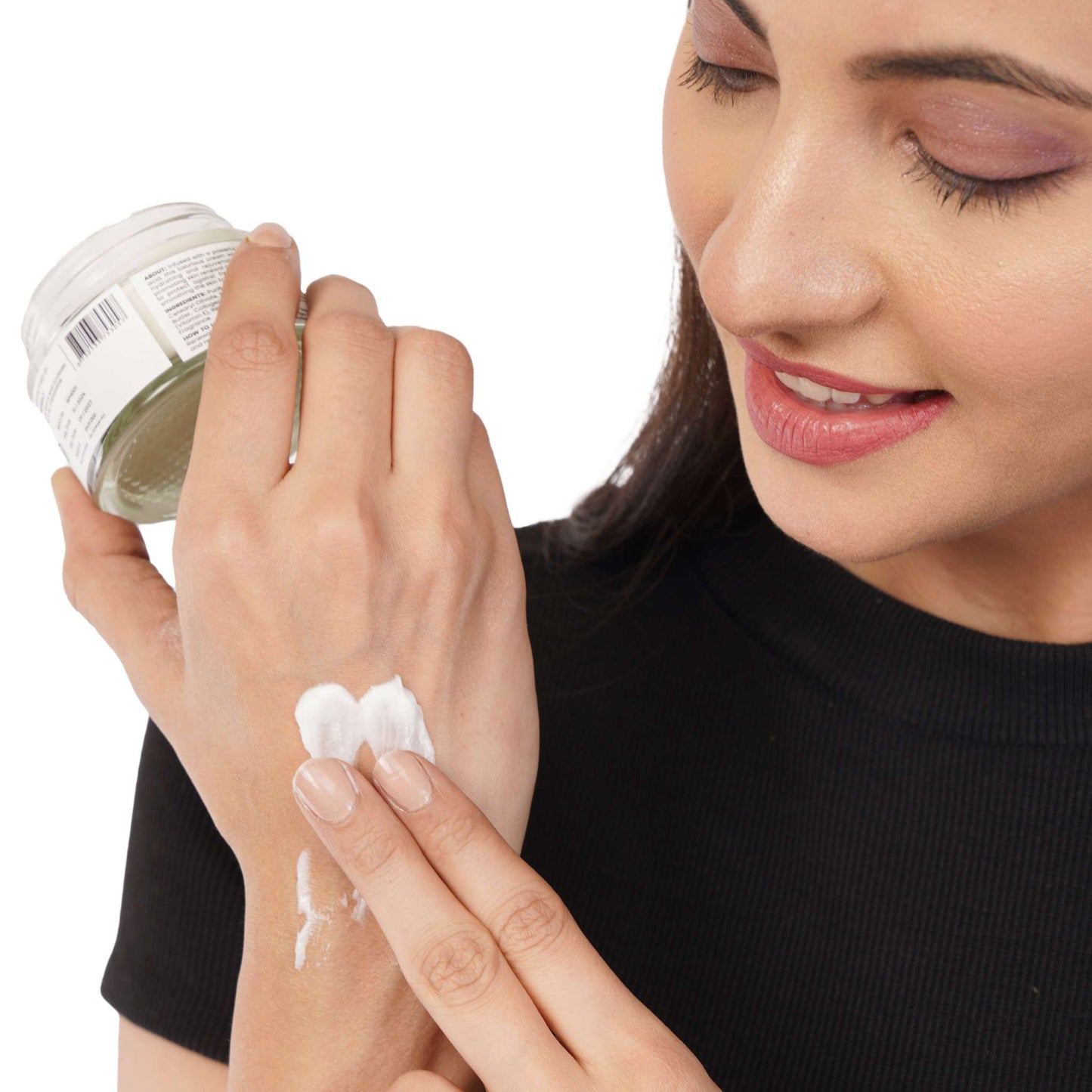 Woman applying anti-wrinkle night cream with Retinol and Aloe Leaf Juice.