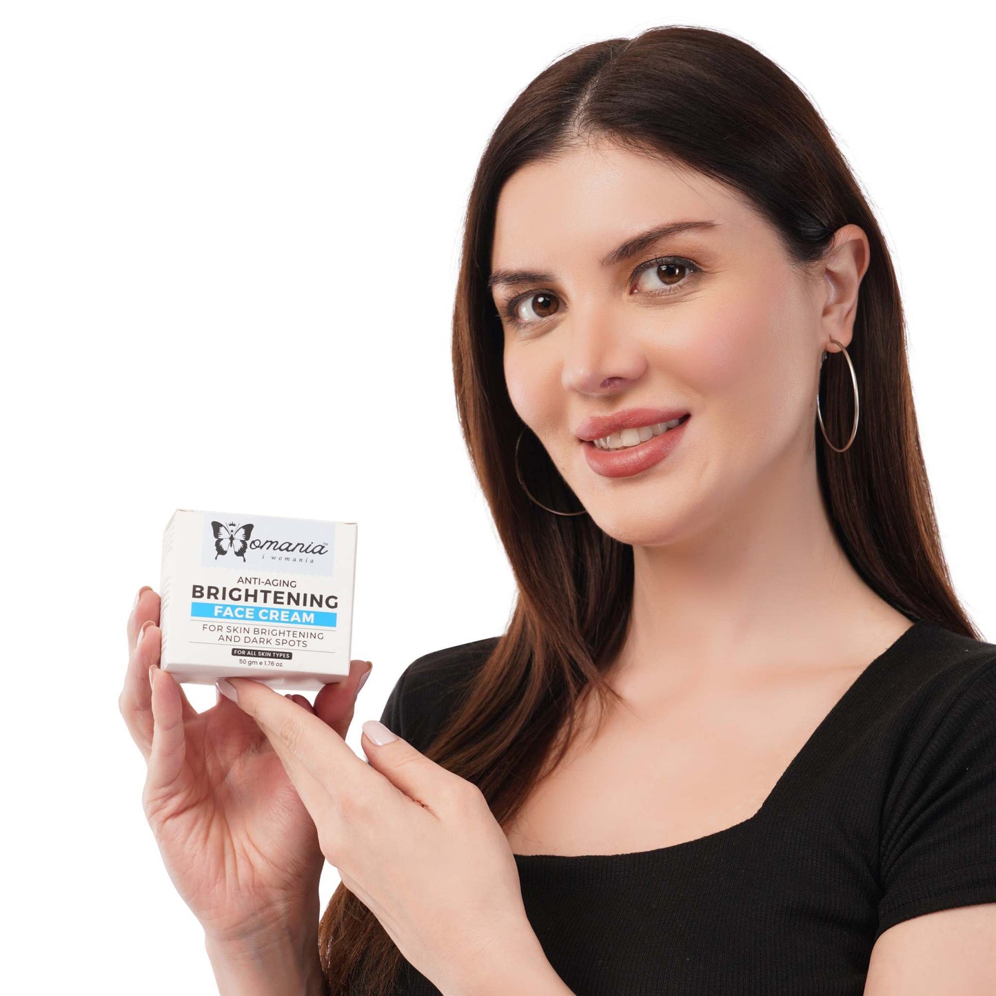 Woman holding a box of brightening cream (anti-aging) with Shea butter, Vitamin C, and Licorice.