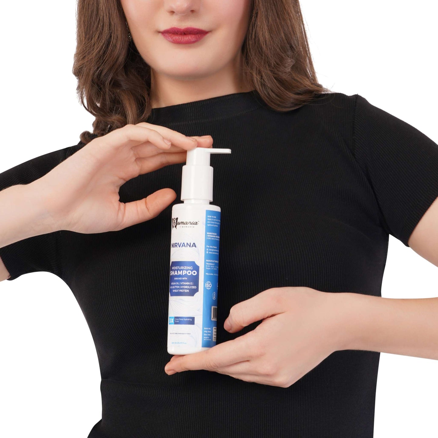 Hair Moisturizing Shampoo 200 ml bottle held by person, enriched with argan oil and vitamin E for deep hydration.