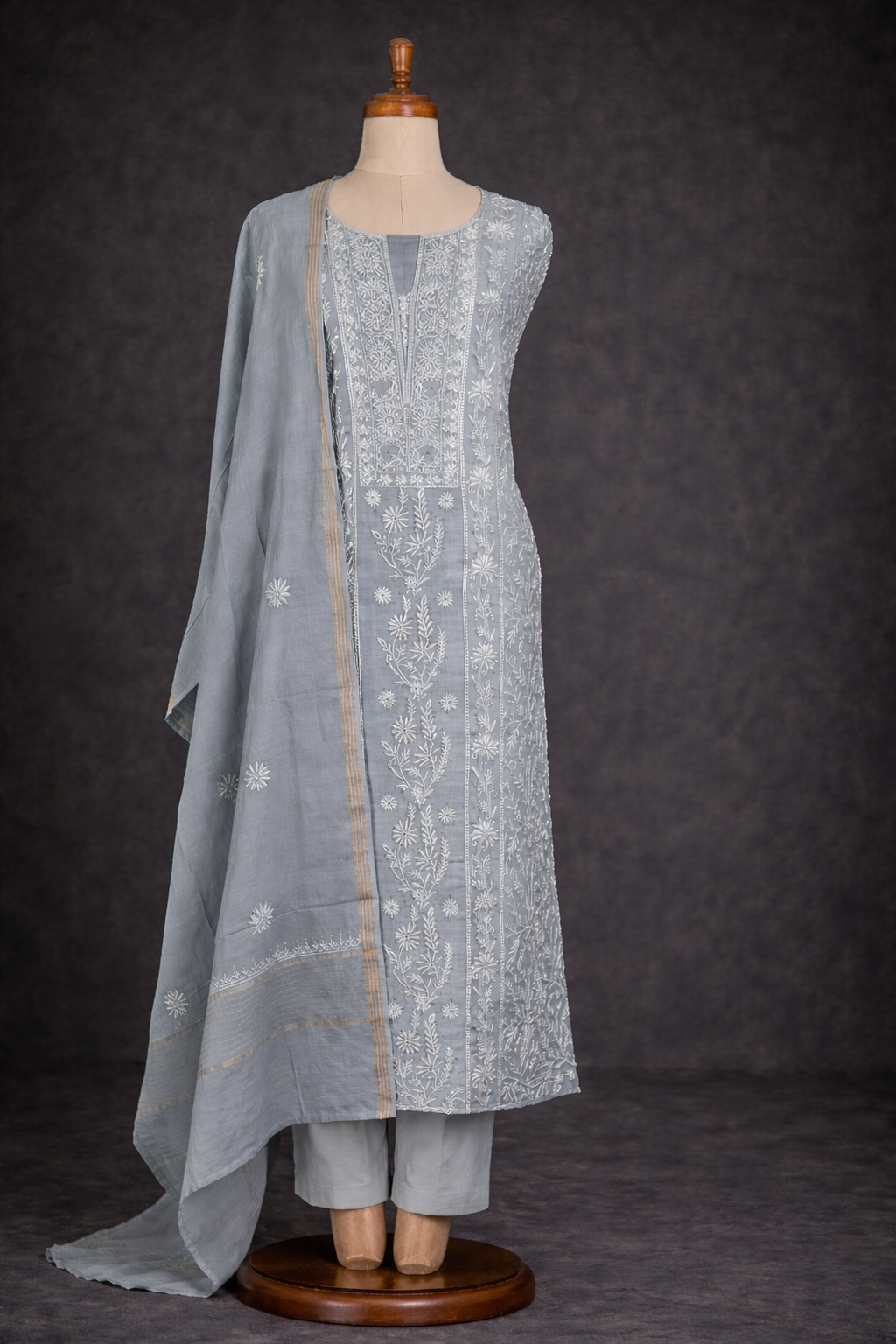 Lucknowi Chikankari unstitched suit in soft grey with intricate hand embroidery and elegant drape.