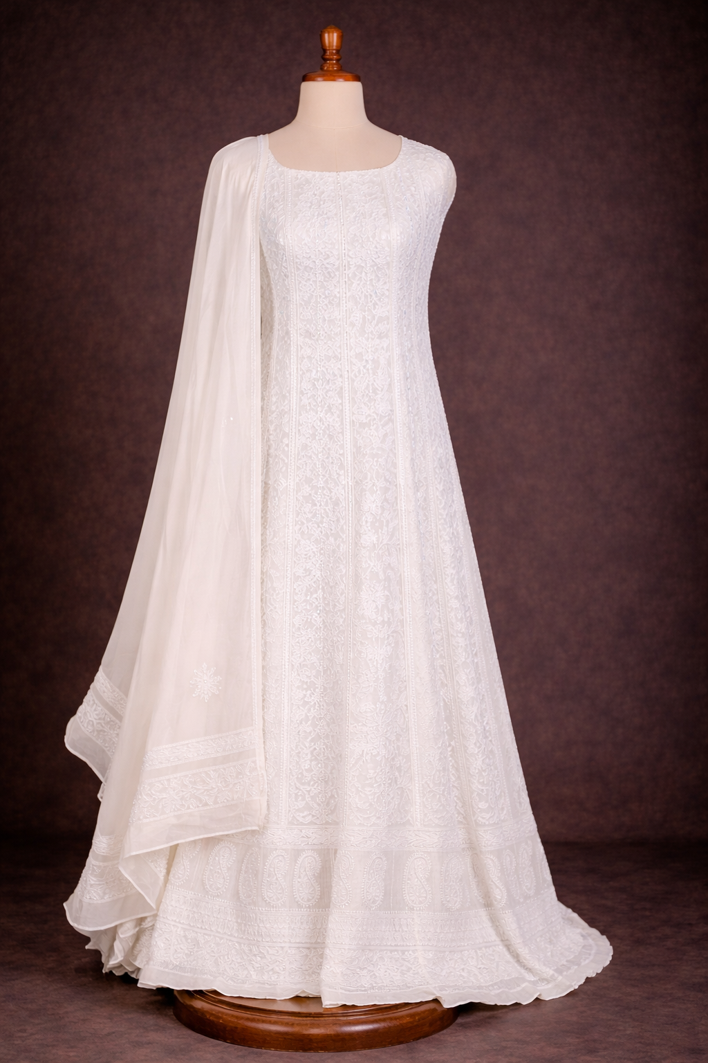 Lucknowi Chikankari Anarkali suit in white, featuring intricate embroidery and a flowing silhouette.
