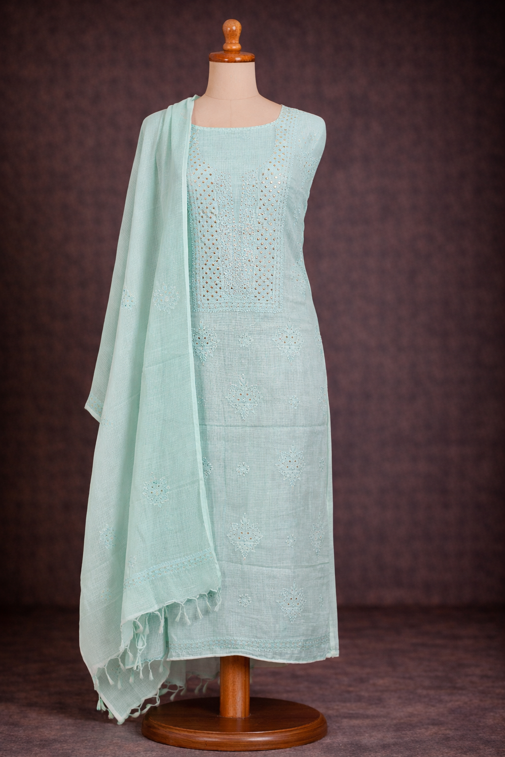Lucknowi chikankari unstitched suit in powder blue color displayed on a mannequin with a dupatta.