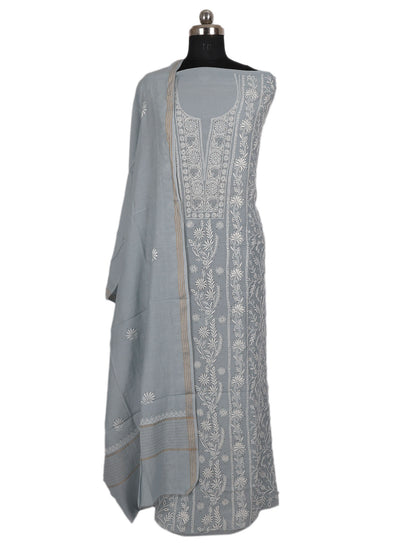 Lucknowi Chikankari unstitched suit showcased on a dress form, featuring intricate hand embroidery in soft grey.